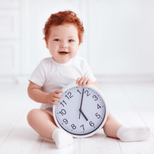  Main image for the article [Why a little hunger is NOT an emergency]. Pictured is a toddler holding a clock.