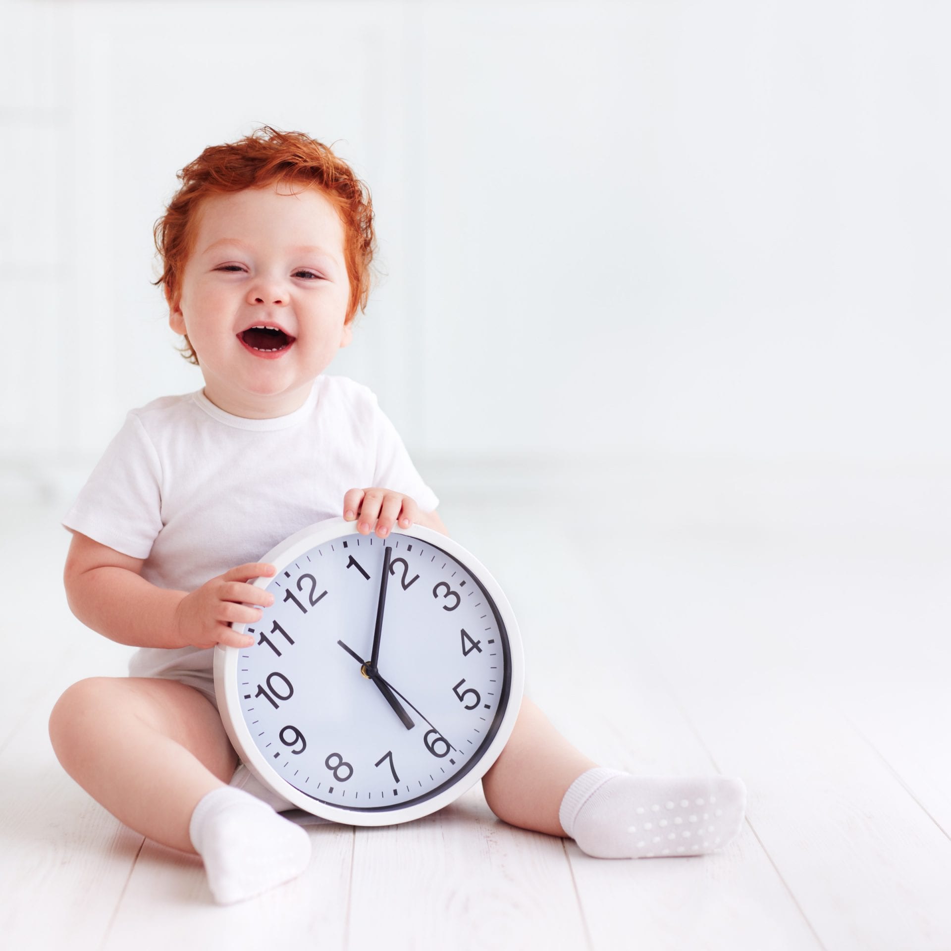 happy little toddler baby holding circle clock My Little Eater Feel