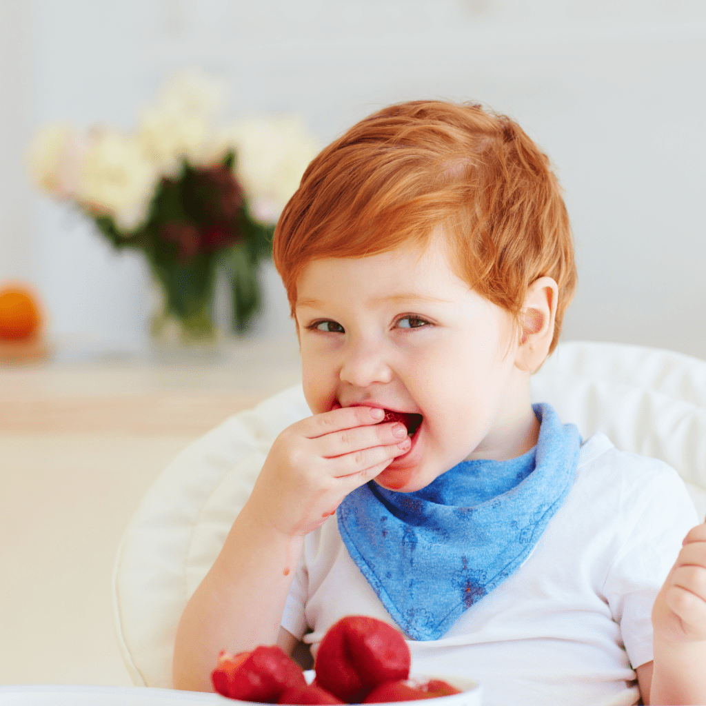 Main image for the article [How to Avoid Catering Meals]. Pictured is toddler eating strawberries and plums.