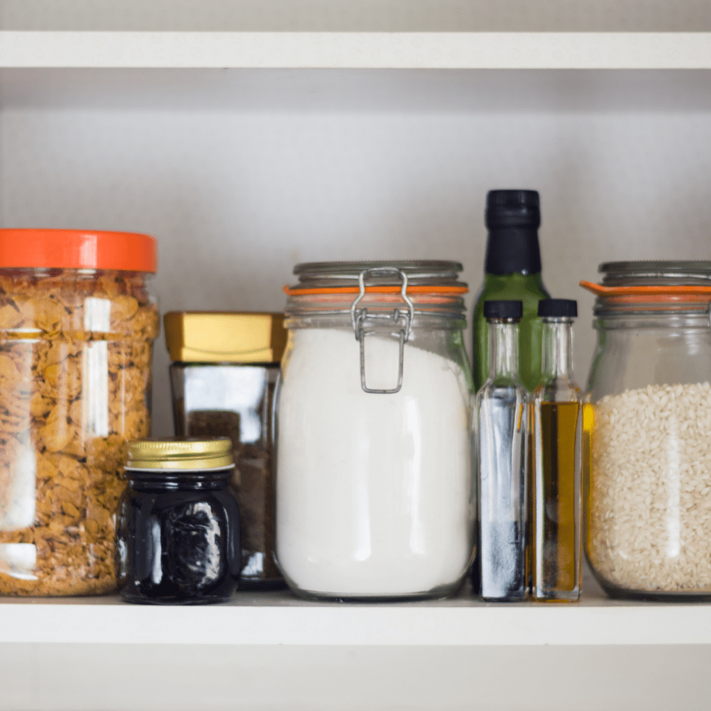 Main image for the article [Family friendly meal ideas to make out of common pantry items]. Pictured is storage jars filled with oils, grains, cereal and sugar.