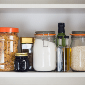 Main image for the article [Family friendly meal ideas to make out of common pantry items]. Pictured is storage jars filled with oils, grains, cereal and sugar. 