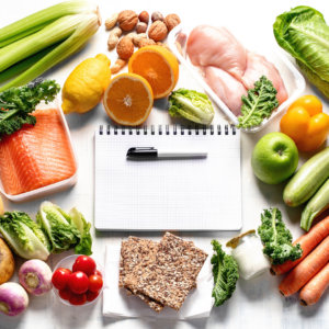 Episode art for episode "#7: Time Management Hacks to Make Cooking for Babies Less Stressful". Pictured is a black note pad and a pen, surrounded by fresh food.