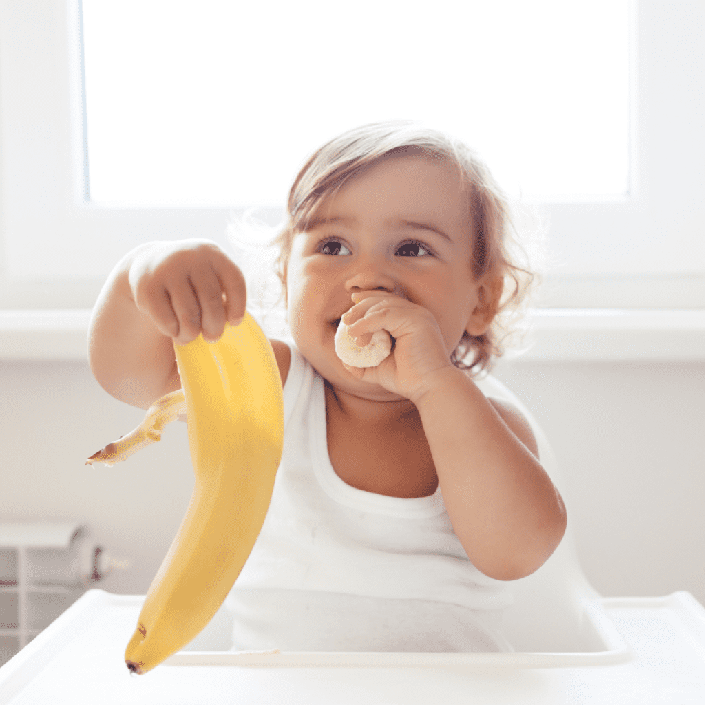 Episode art for episode "#11: How to Stop Food Throwing - For Good!". Pictured is a baby eating a banana and smiling.