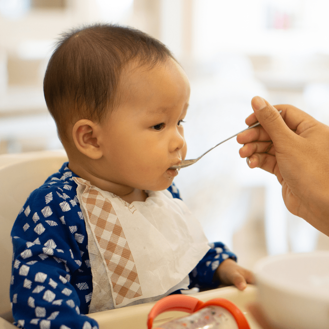 Episode art for episode "#35: Food Substitutions for When Your Baby has Allergies". Pictured is a baby being spoon-fed puree.