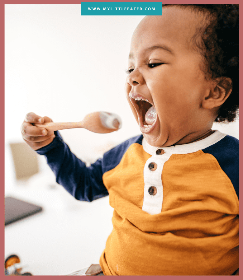 Episode art for episode: "Bonus: Toddler Led Feeding". Pictured is a toddler moving towards a spoon to take a bite.