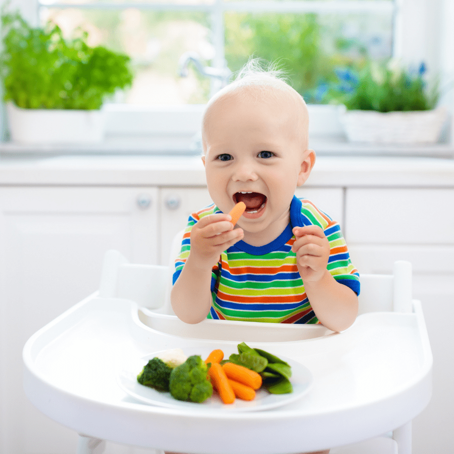 Featured image for article: "Choking prevention and when food modifications are no longer needed". Pictured is a baby eating a baby carrot.