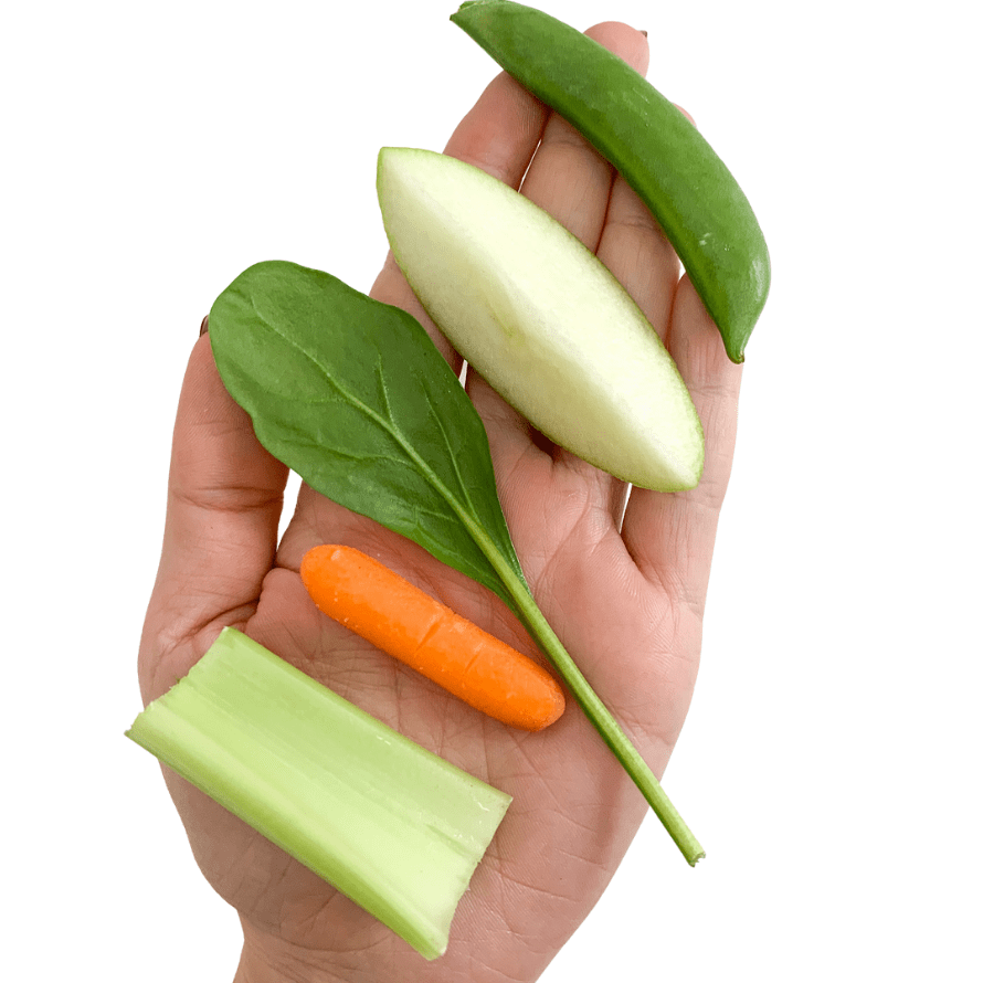Episode art for episode: "#52: When to stop modifying foods that are choking risks". Pictured is a piece of celery, a carrot, a spinach leaf, a wedge of apple, and a snap pea in the palm of a hand.