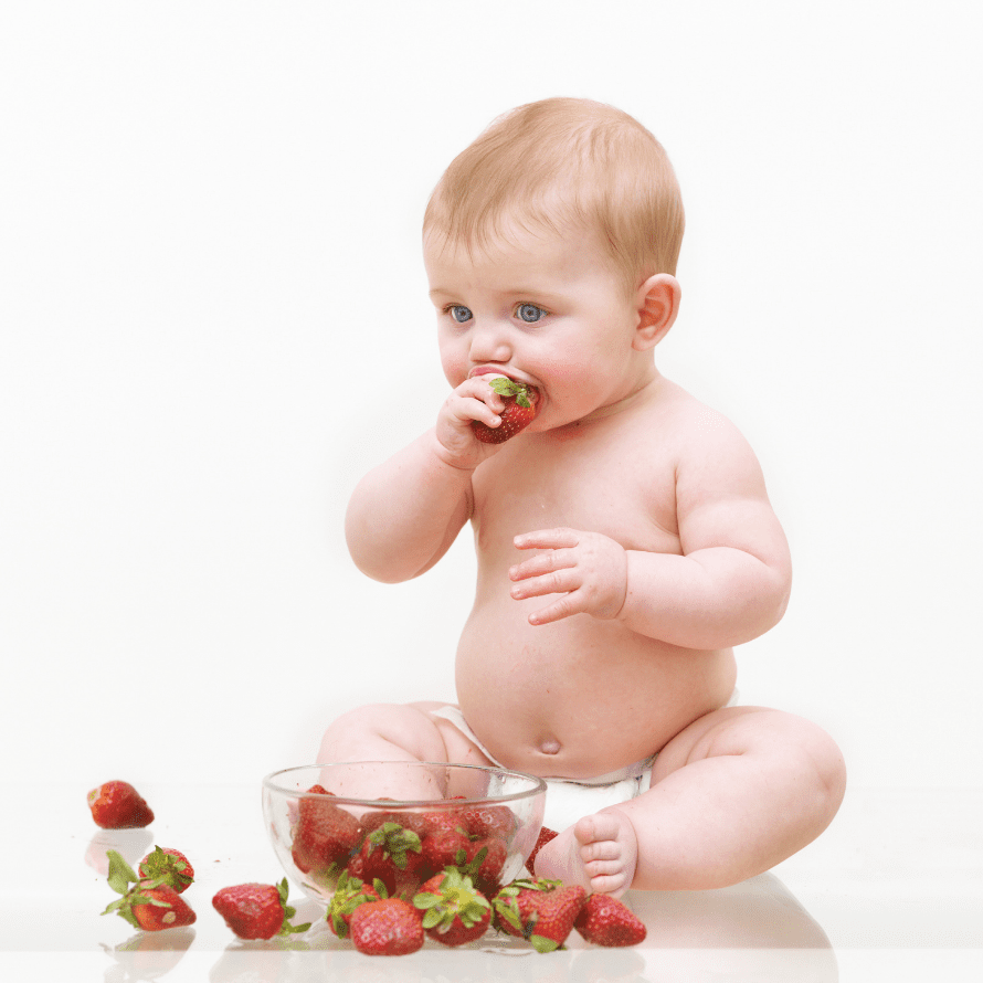 Episode art for episode: "#63: How to serve strawberries to your baby or toddler". Pictured is a baby eating a strawberry.