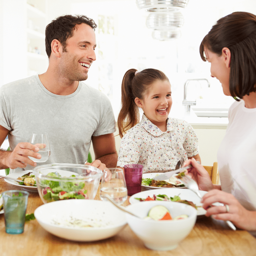 Featured image for article: "Kid's Table or Family Table - Does it really matter?". Pictured is a family dining together.