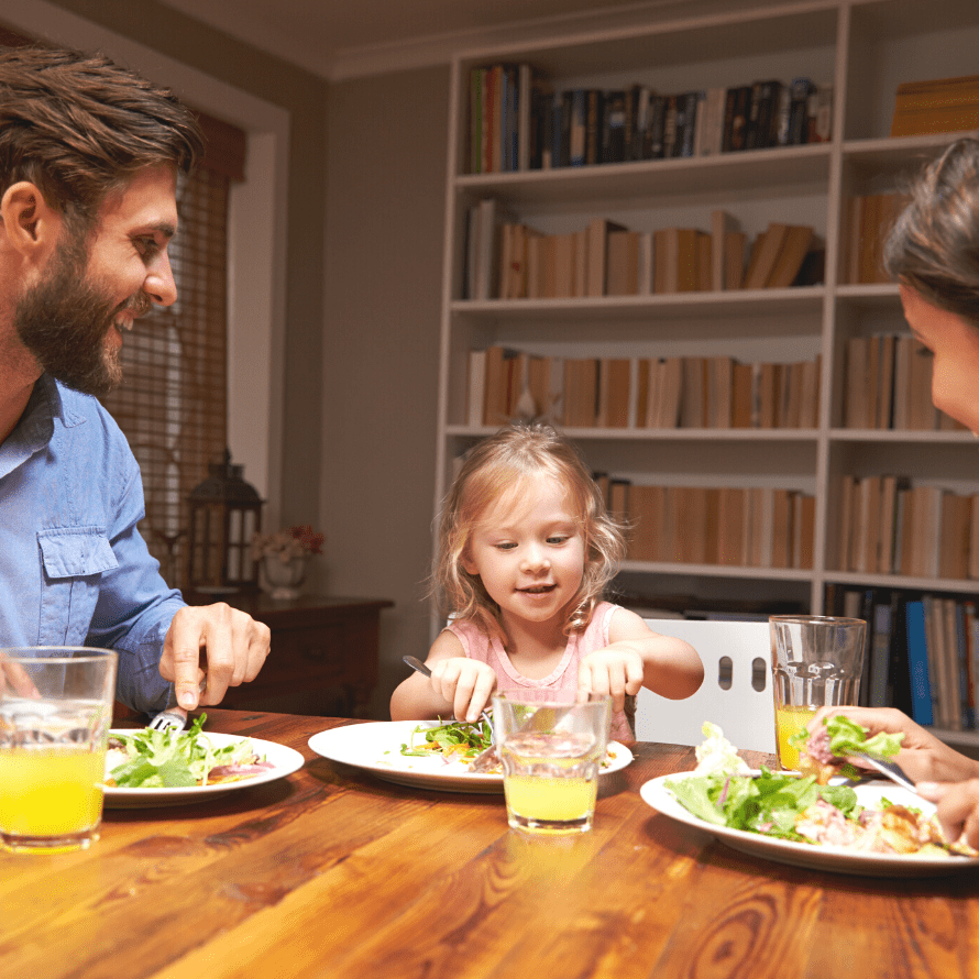 child eats with family