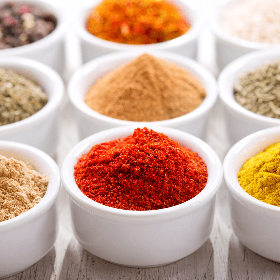 Featured image for article: "Why you need to add spices to your baby’s food". Pictured is a variety of spices in jars.