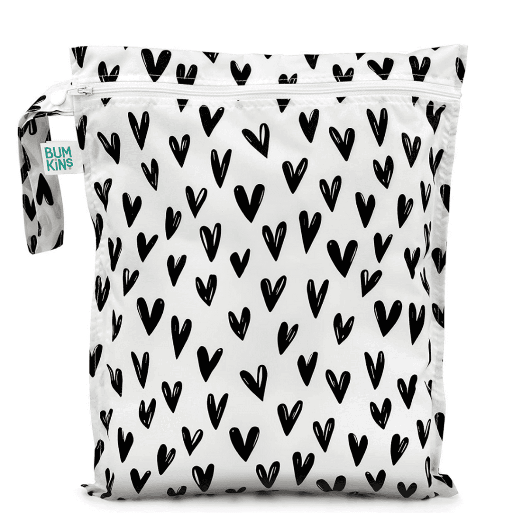 Bumkins waterproof baby bag with black hearts all over it.