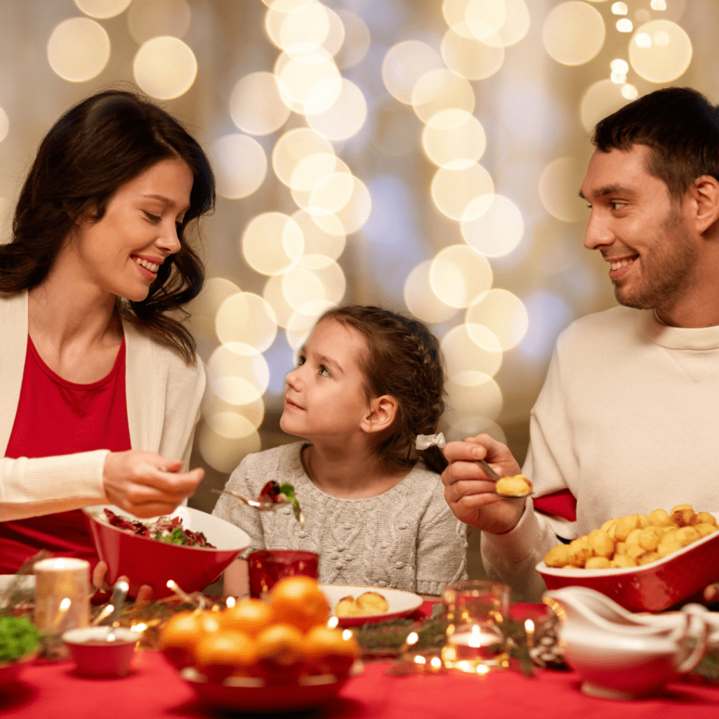Little girl eating holiday dinner with family