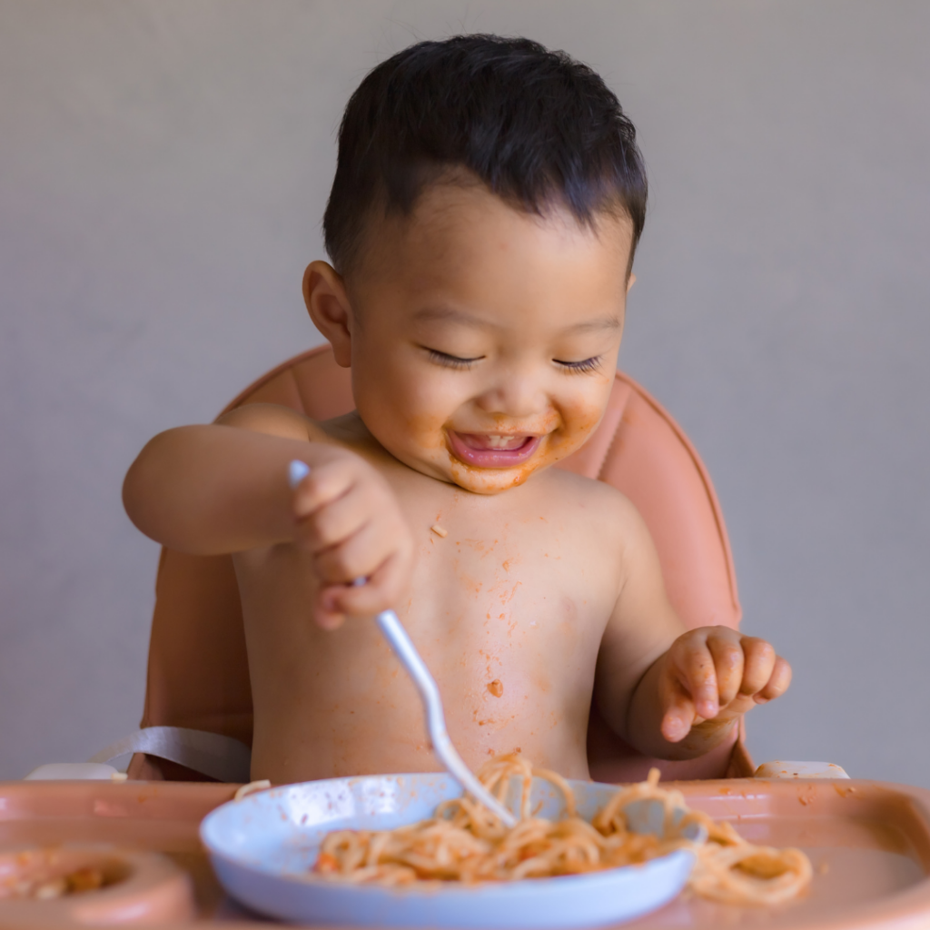 baby eating pasta with baby meatballs made with various spices