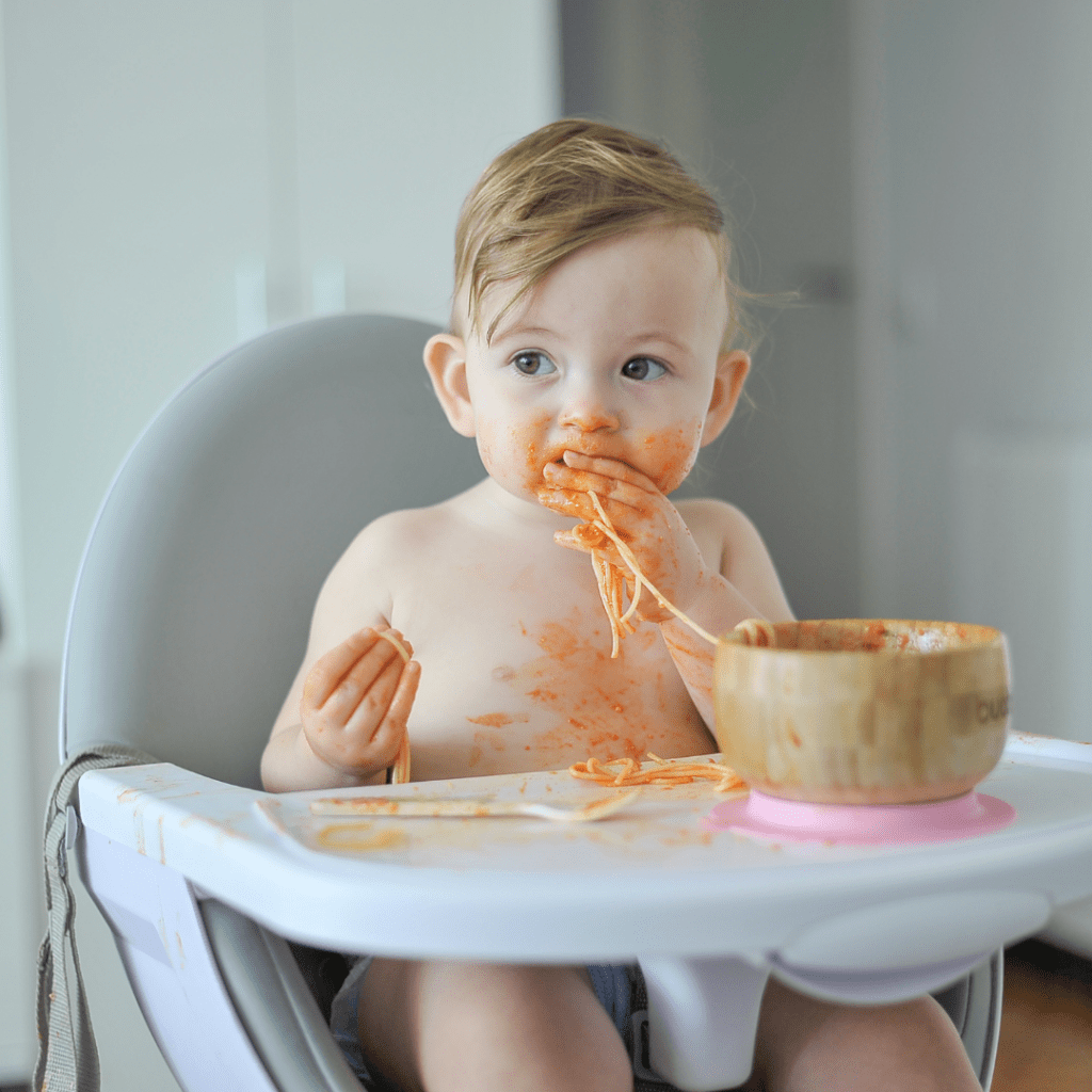 spitting out food and baby makes a mess