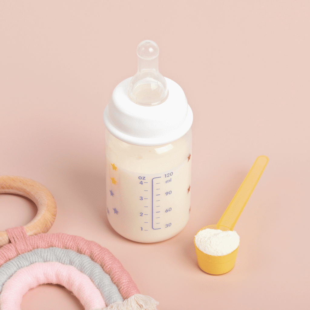 starting solid food at 4 months; milk in a bottle and a scoop of formula