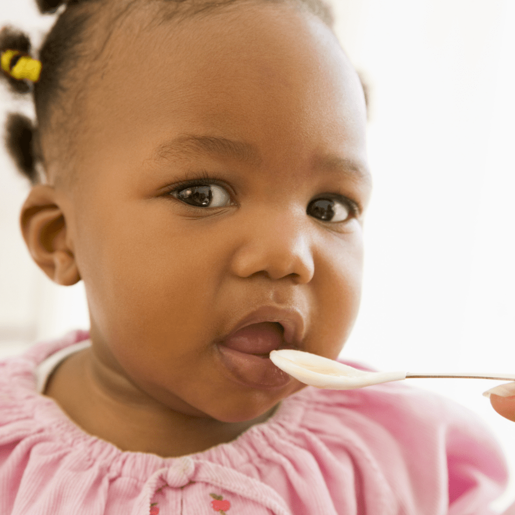 understand the difference between gagging and choking; image of baby with spoon being brought to mouth