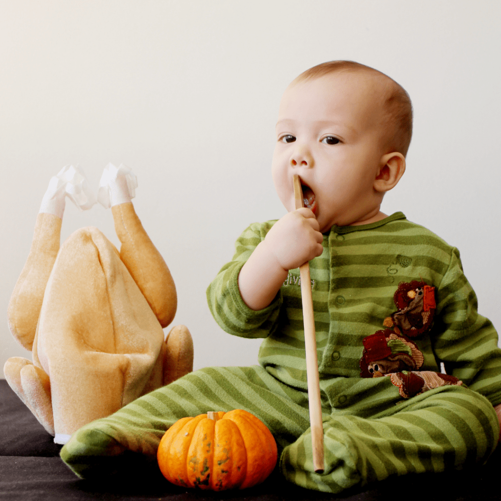 Baby with a stuffed turkey; baby led weaning holidays.