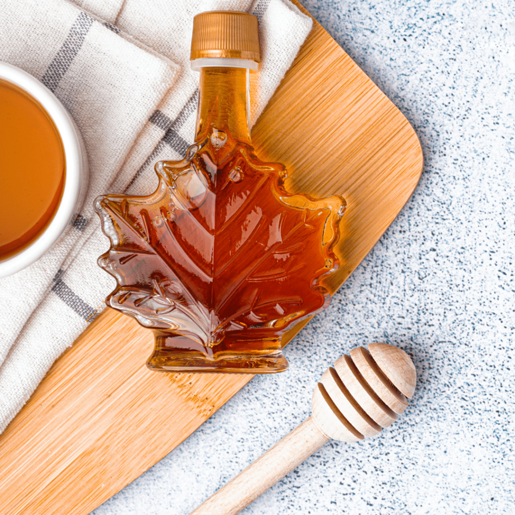A bottle of syrup in the form of a maple leaf. 