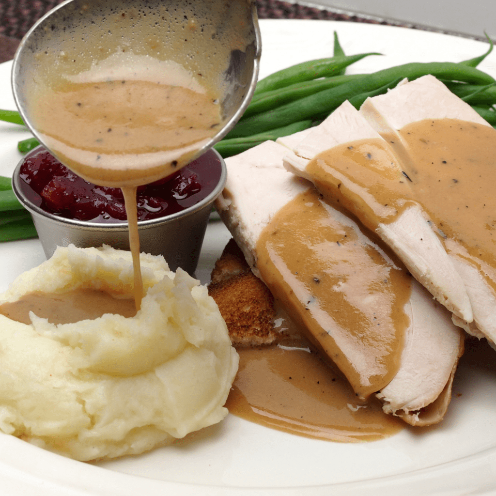 Mashed potatoes with gravy on top.