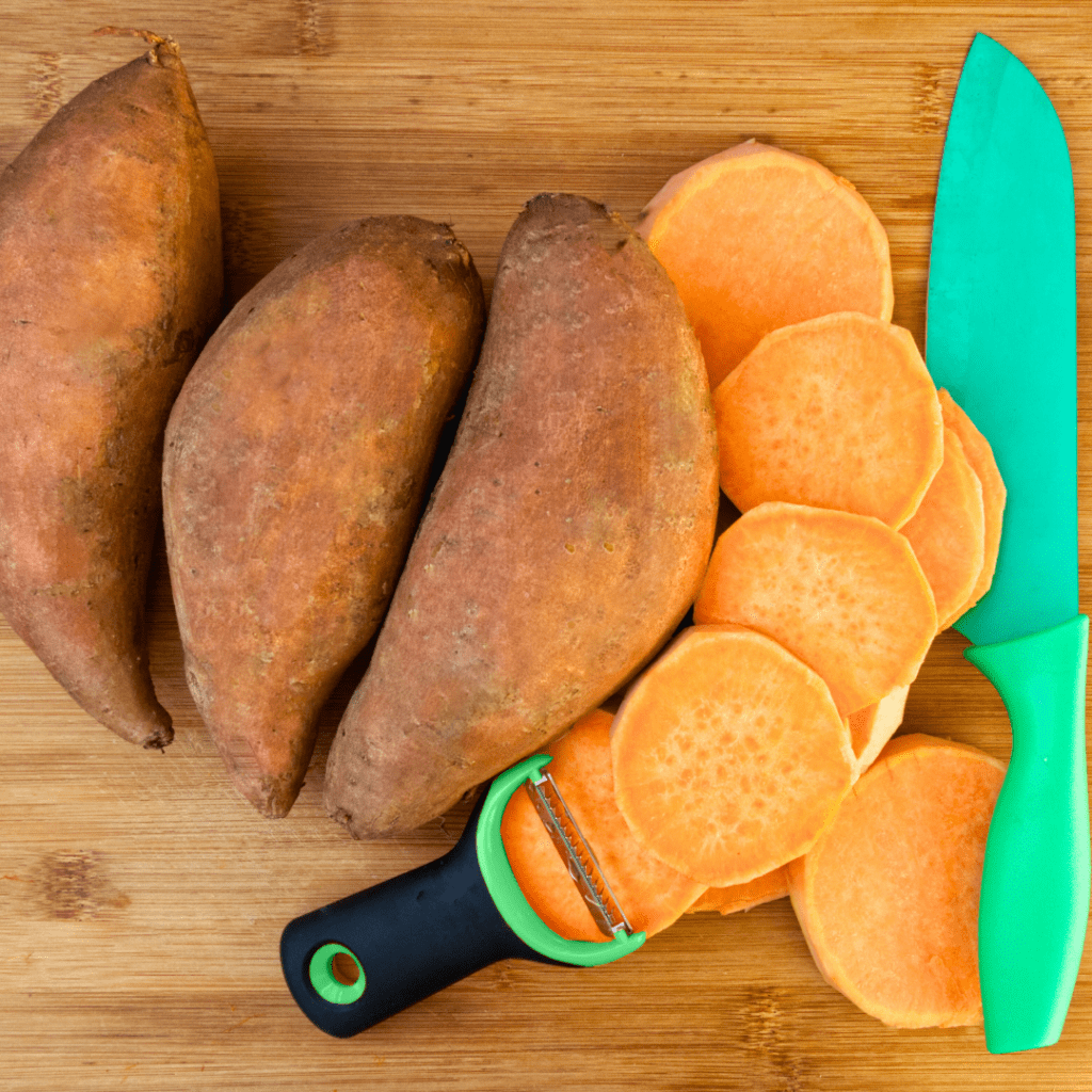 Sweet potato being prepped and cut for dinner.