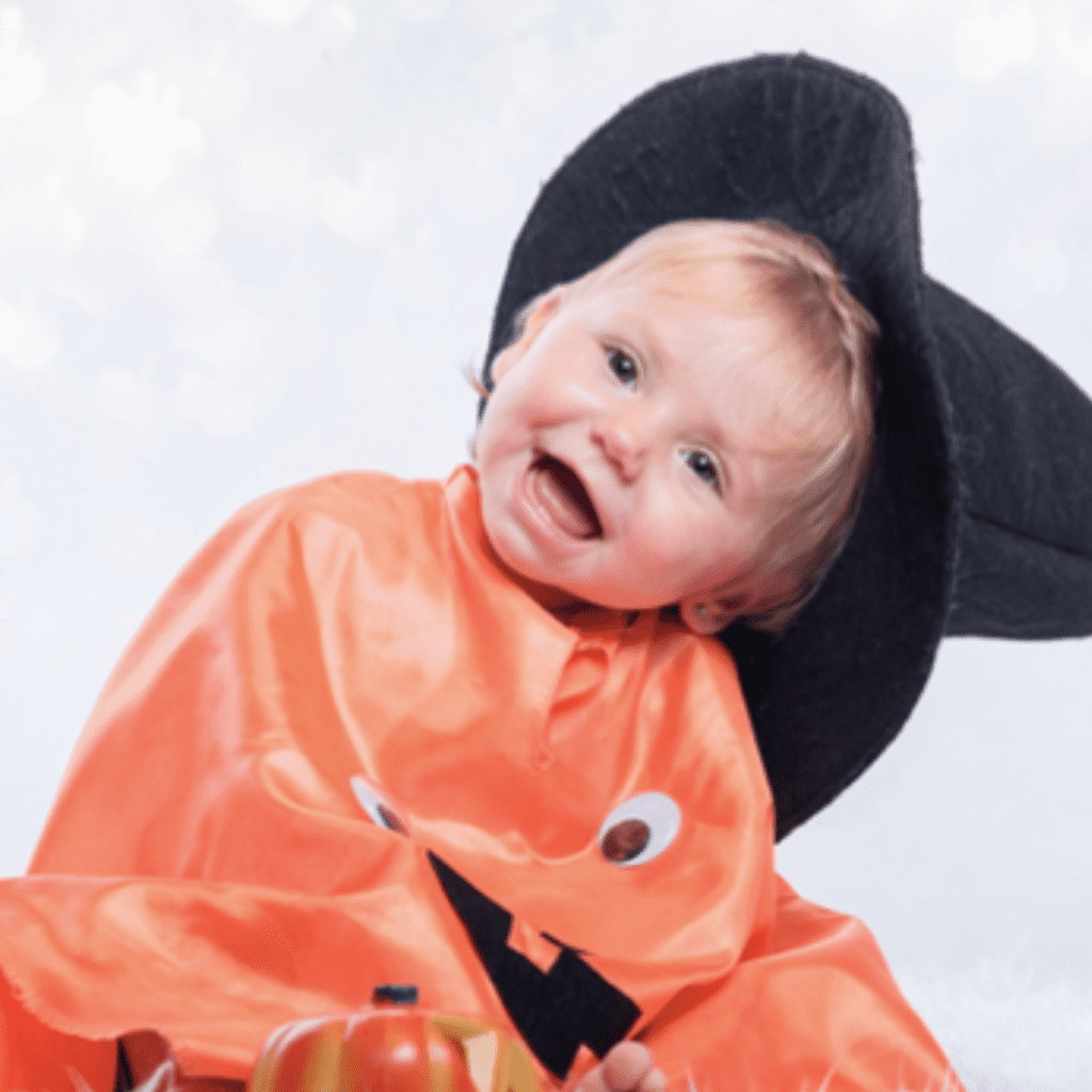 How to handle halloween candy for toddlers. A toddler dressed up in a witch costume.