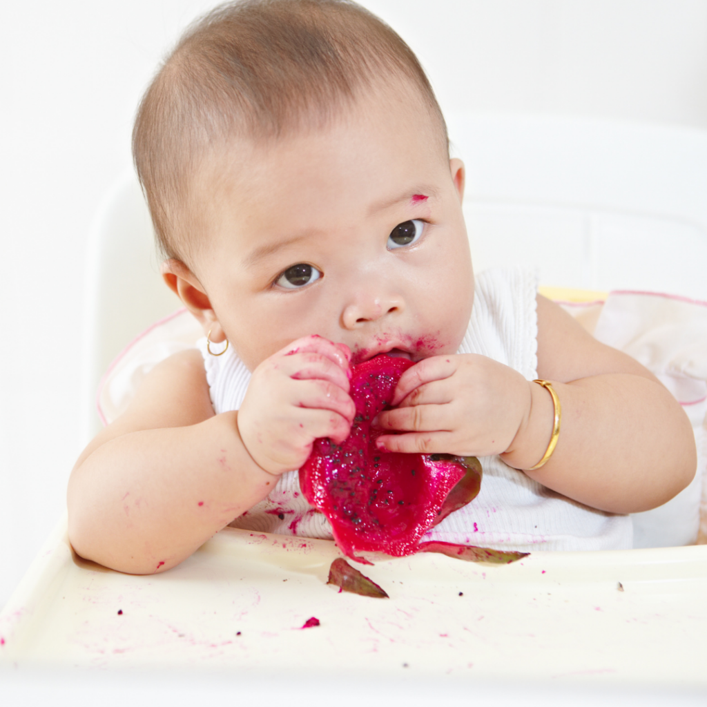 Baby eating and enjoying textured foods with baby led weaning.