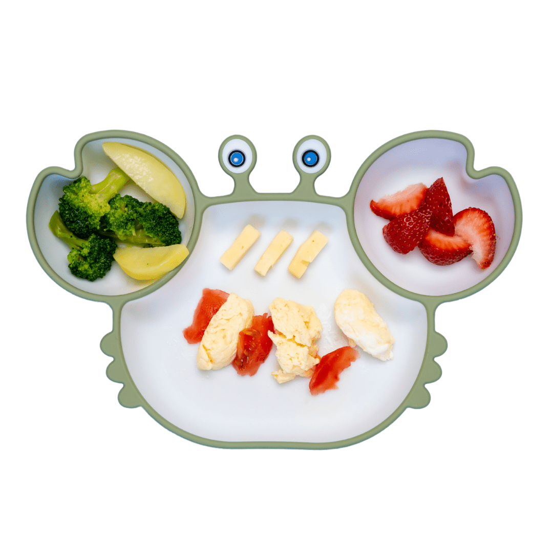 First foods for baby including strawberries, broccoli, and chicken.