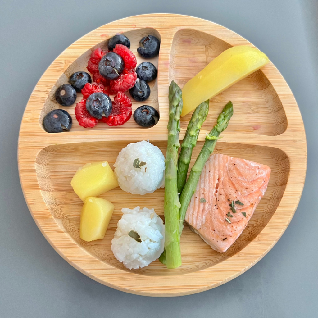 First foods for baby led weaning including cooked asparagus (raw vegetables are a choking hazard), salmon, and fruits.
