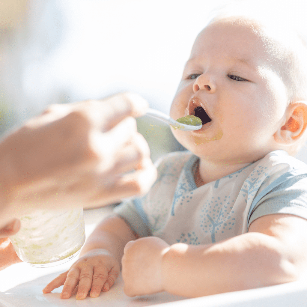 Baby eating solids; learn about the connection between solids at 6 months and sleep.