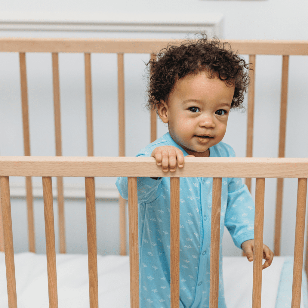 How to stop night feedings and still make sure babies sleep well; a baby wide awake in their crib.