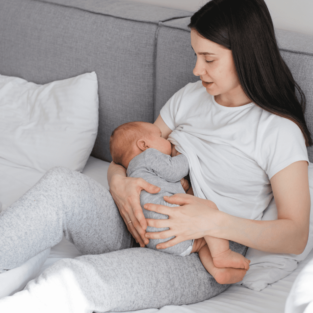 When to drop night feedings; a baby nurses from mom in bed.