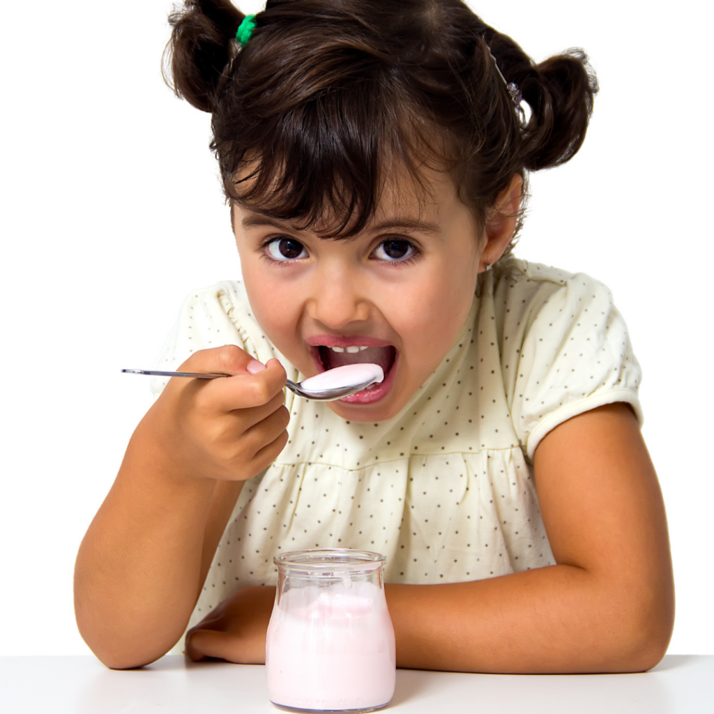 Avoid yogurts with added sugars for babies and toddlers; toddler eats a flavored yogurt from a jar.