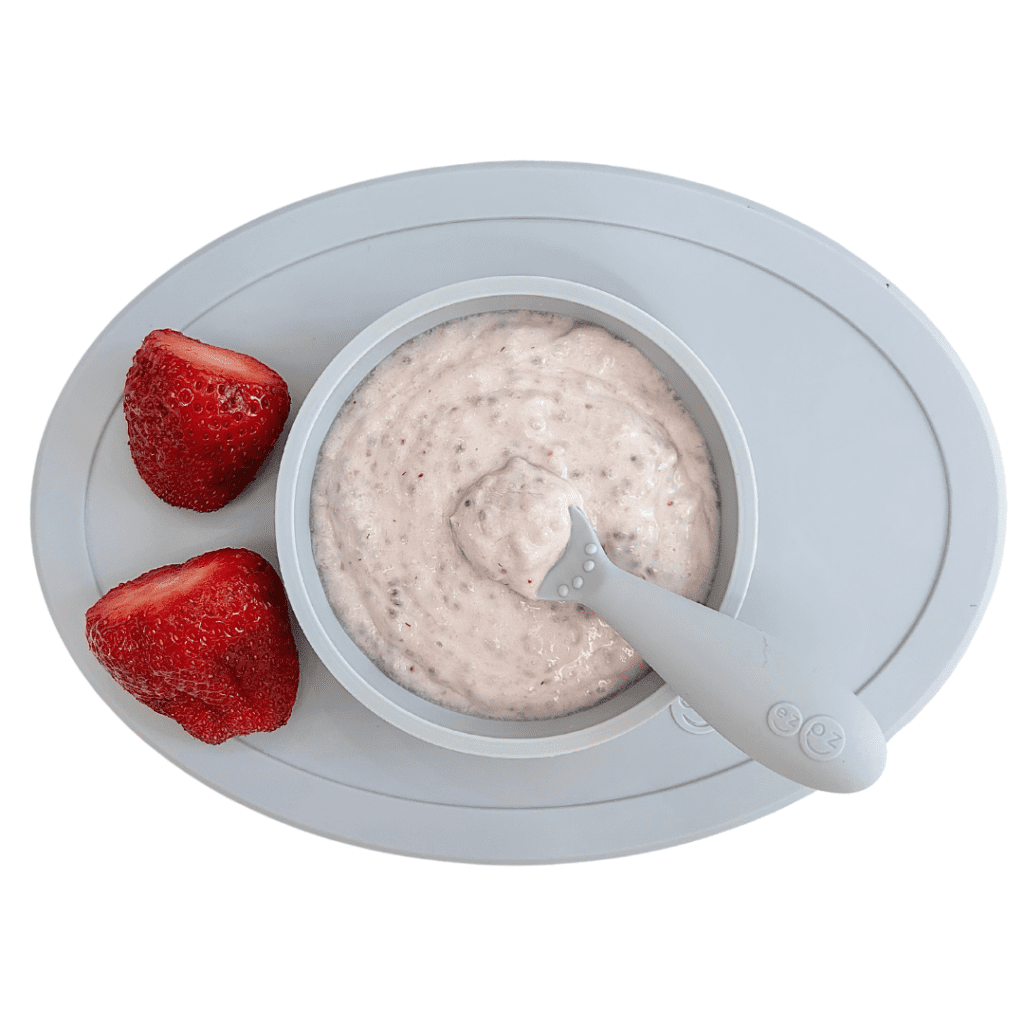Babies can start eating yogurt at 6 months when they start solids; the best yogurt for babies mixed with chia seeds and served with strawberries on the side.