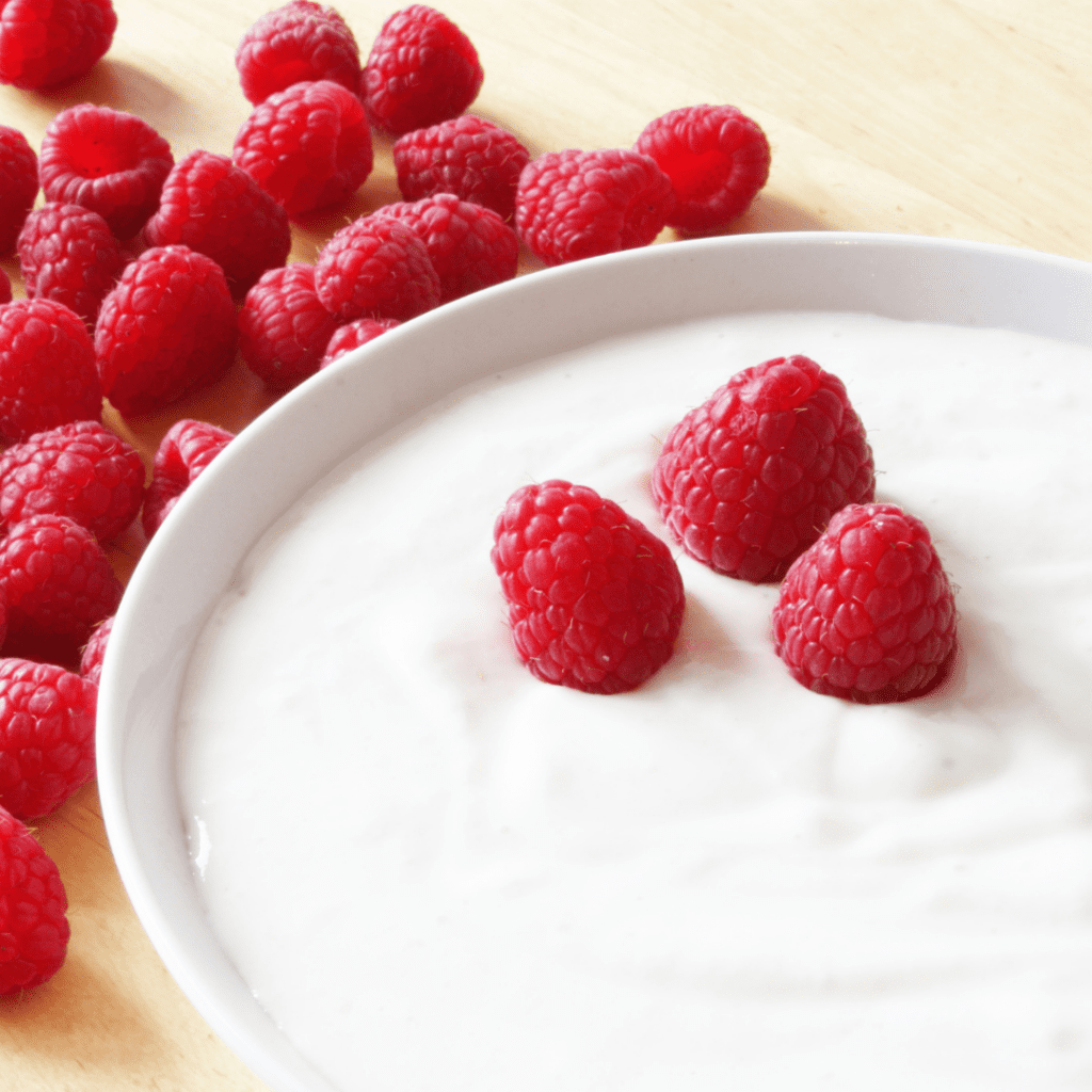 How to naturally flavor plain yogurt, for example by adding fruits like raspberries.