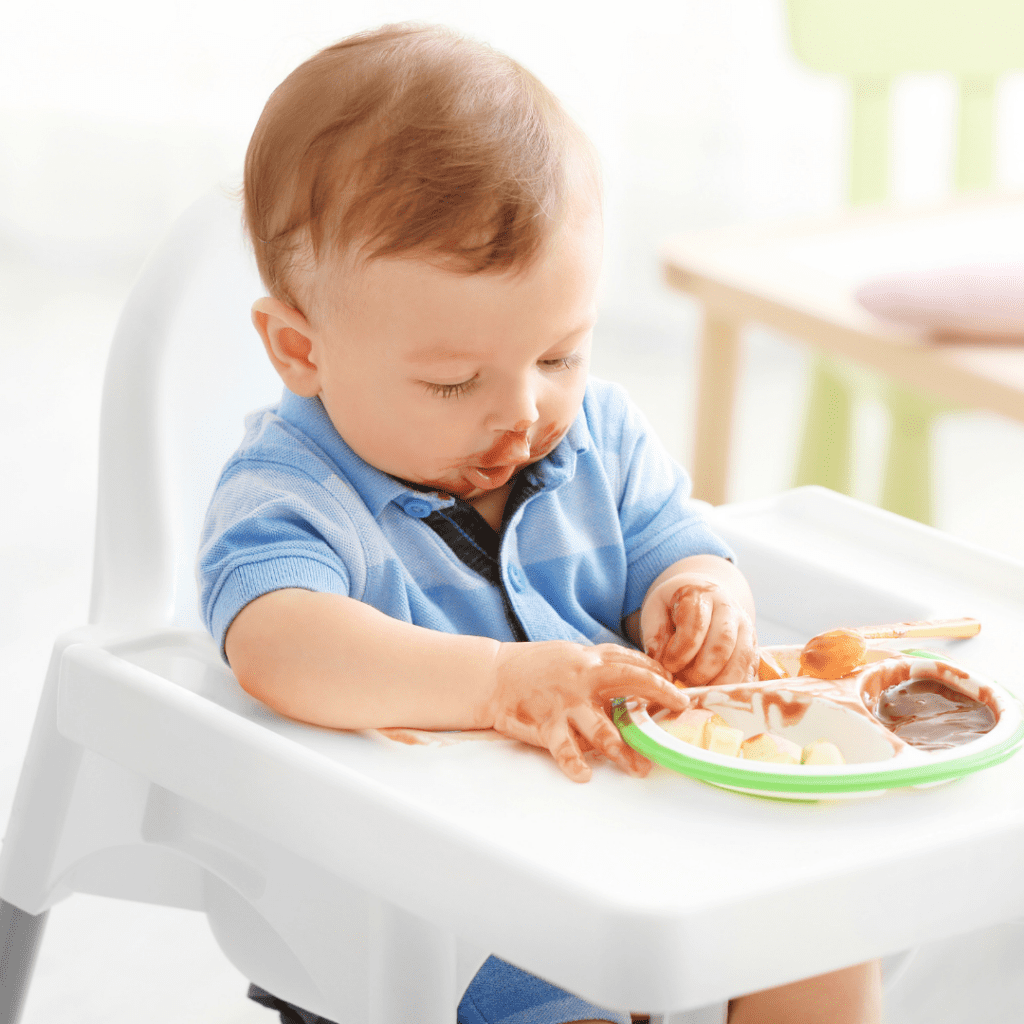 Baby eating a combination of purees and table foods in their high chair.