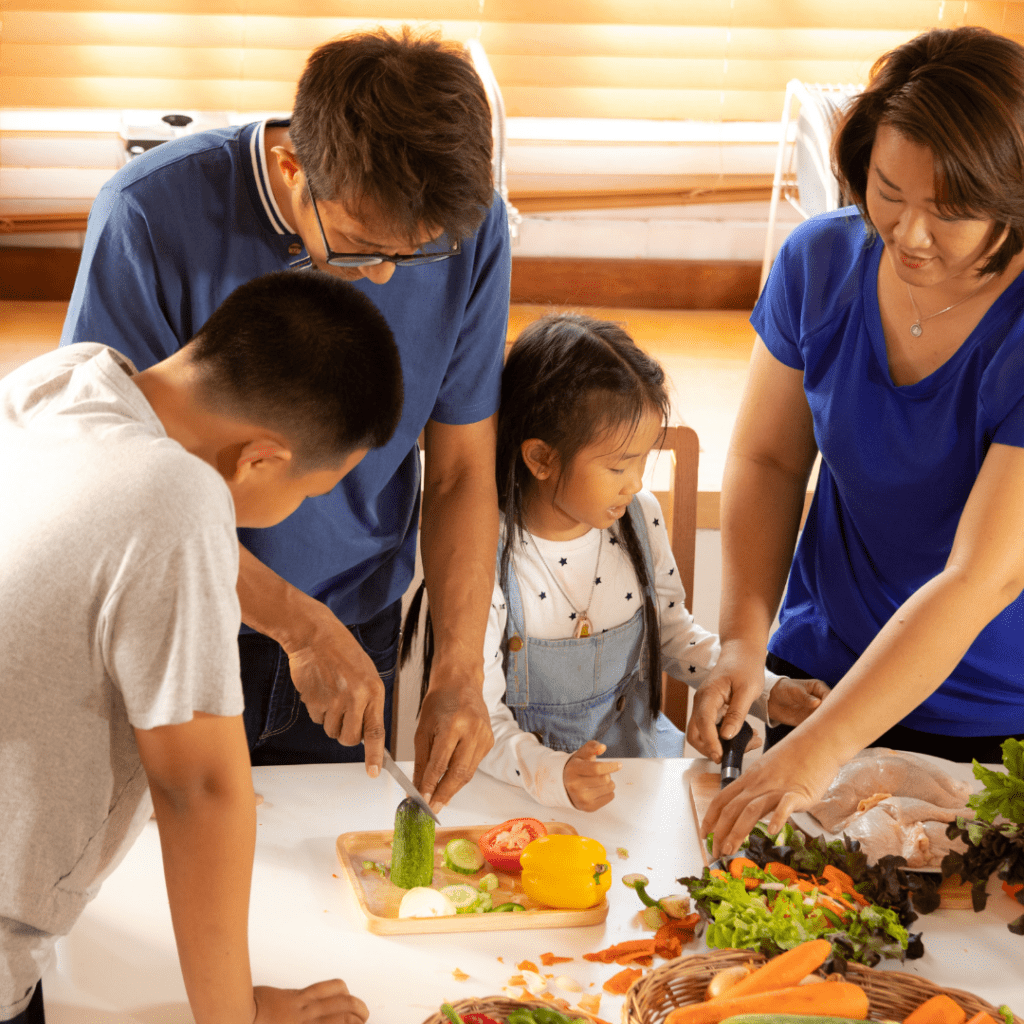 Here a family cooks together as a fun way to enjoy time together; start cooking favorite recipes when kids are young.