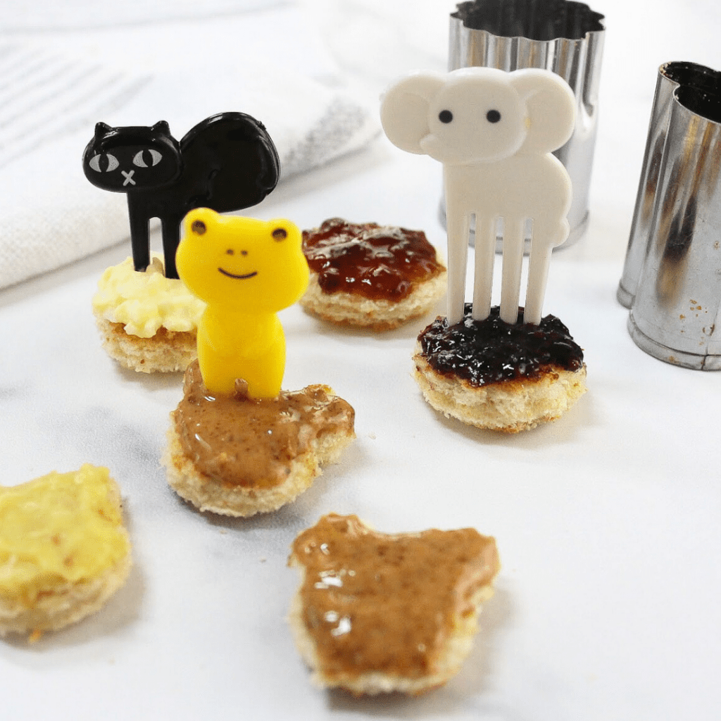 Small pieces of toast with fun food picks stuck in them.