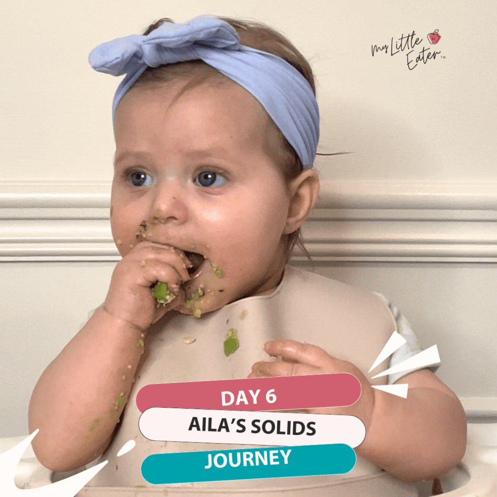 Day 6 of Aila's solids journey; Aila eating a piece of avocado.