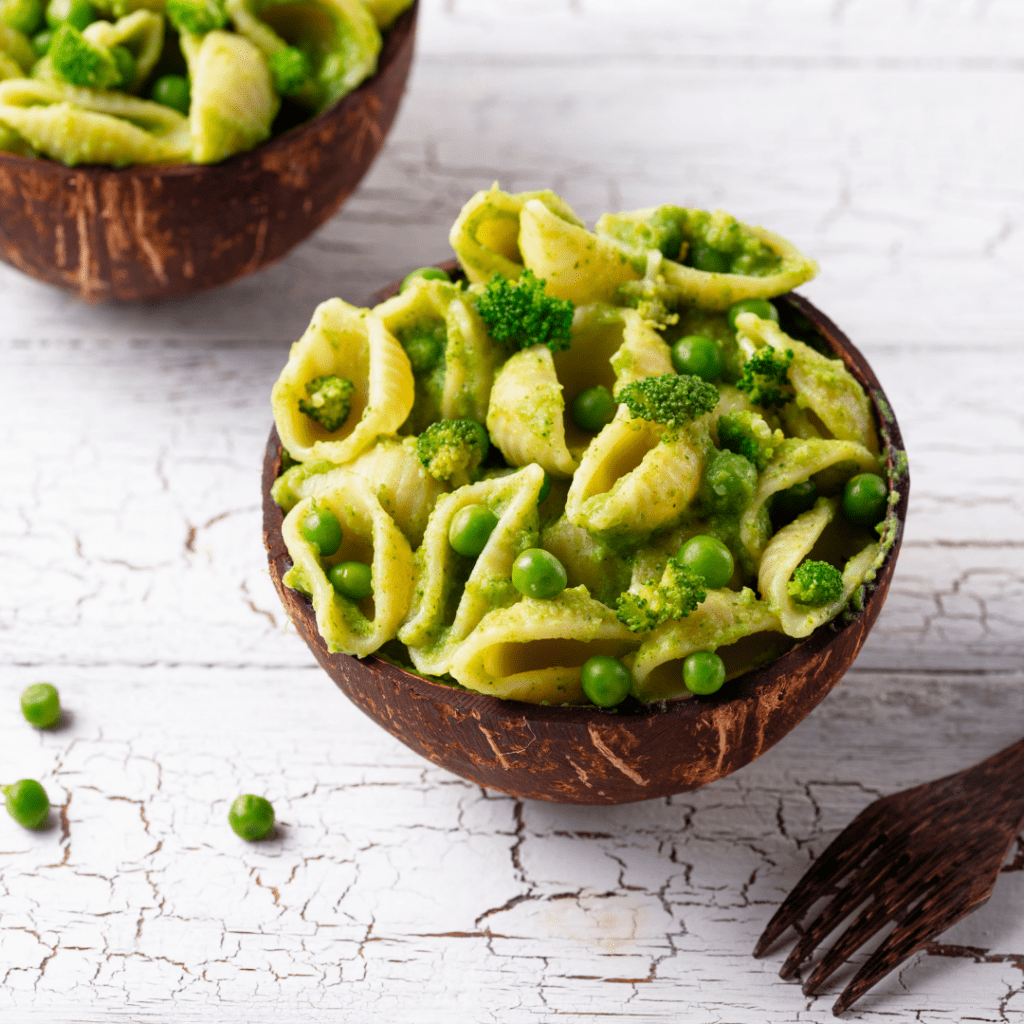 Pasta for baby led weaning; shell shaped pasta in a bowl mixed with peas.