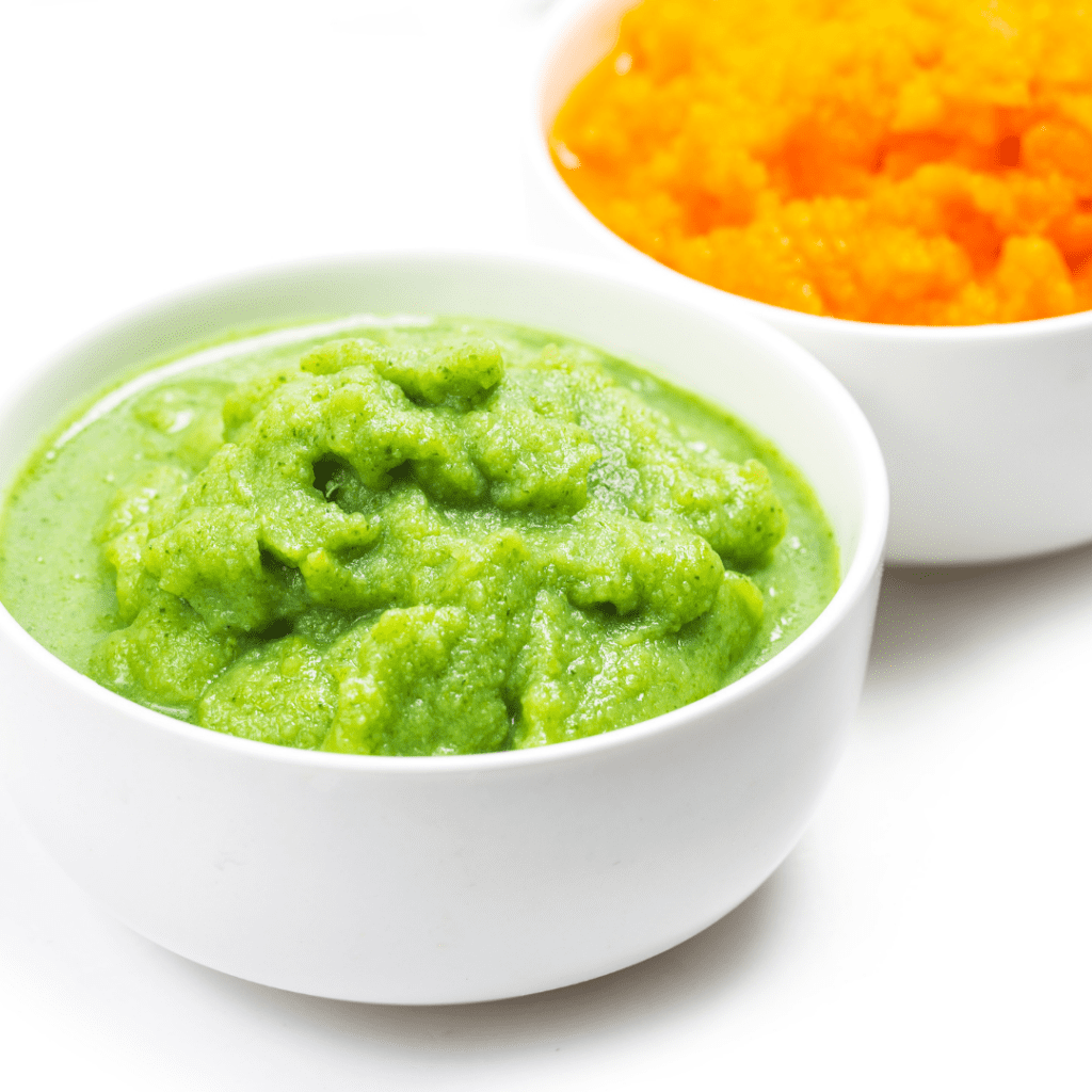 A green puree in a bowl and an orange puree in a bowl.