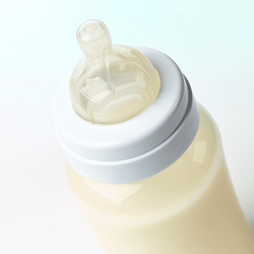A baby bottle full of milk.