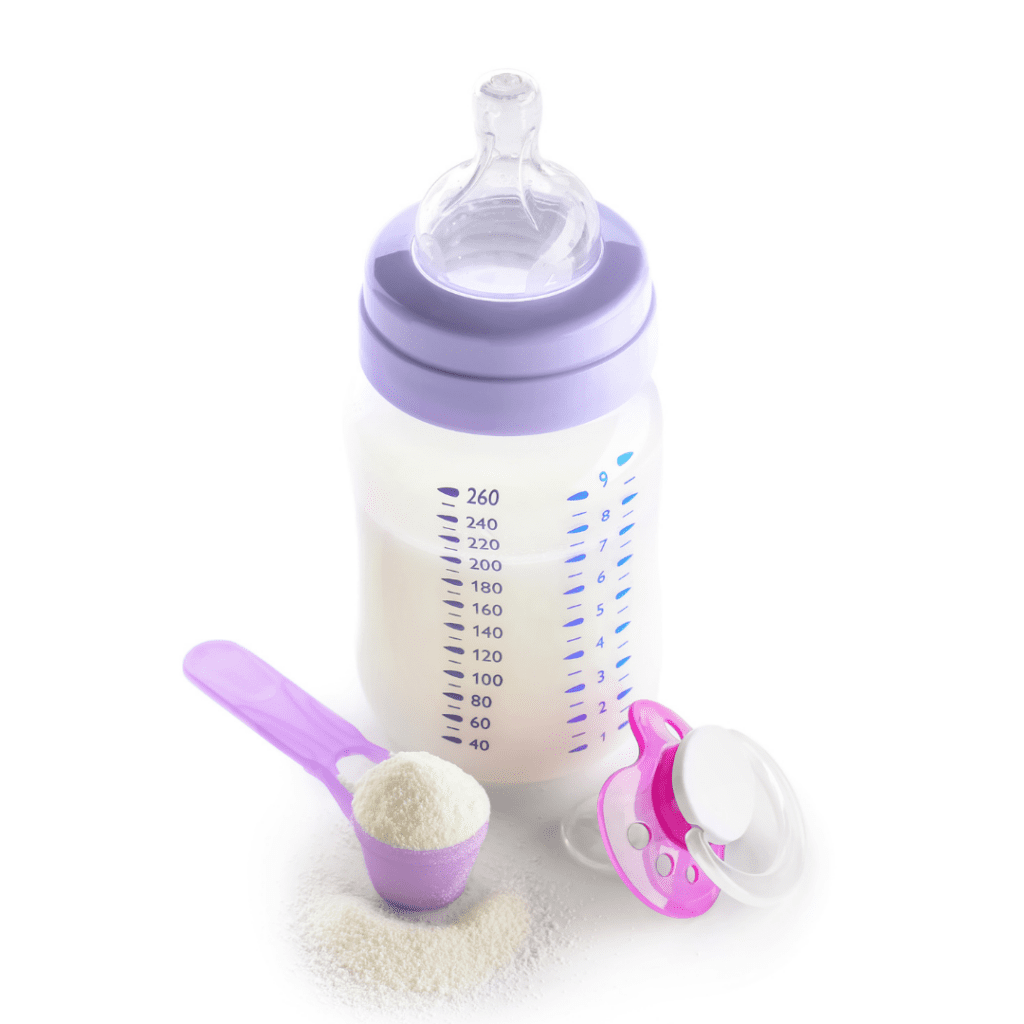 A bottle of baby formula with a purple lid, with a scoop of baby formula and pacifier sitting next to it.