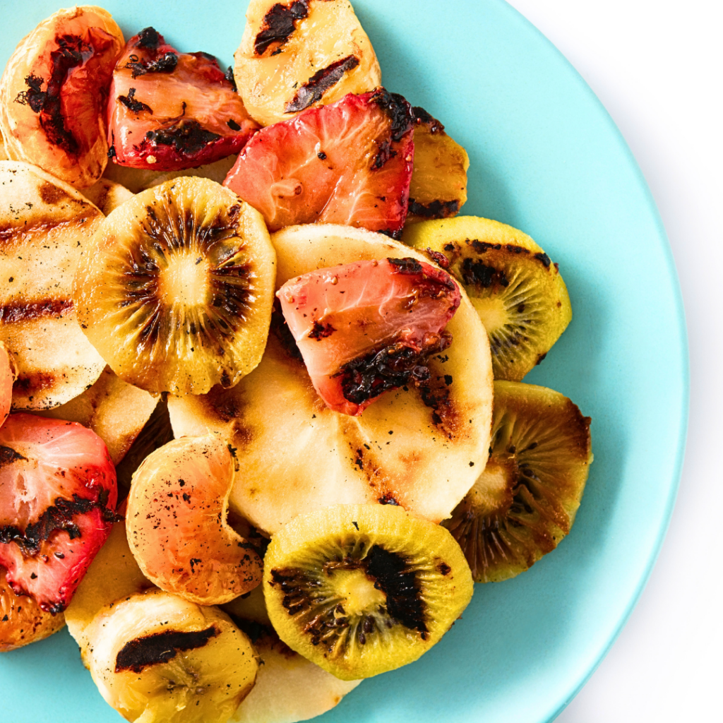Grilled bananas, kiwi, strawberries, and clementines.