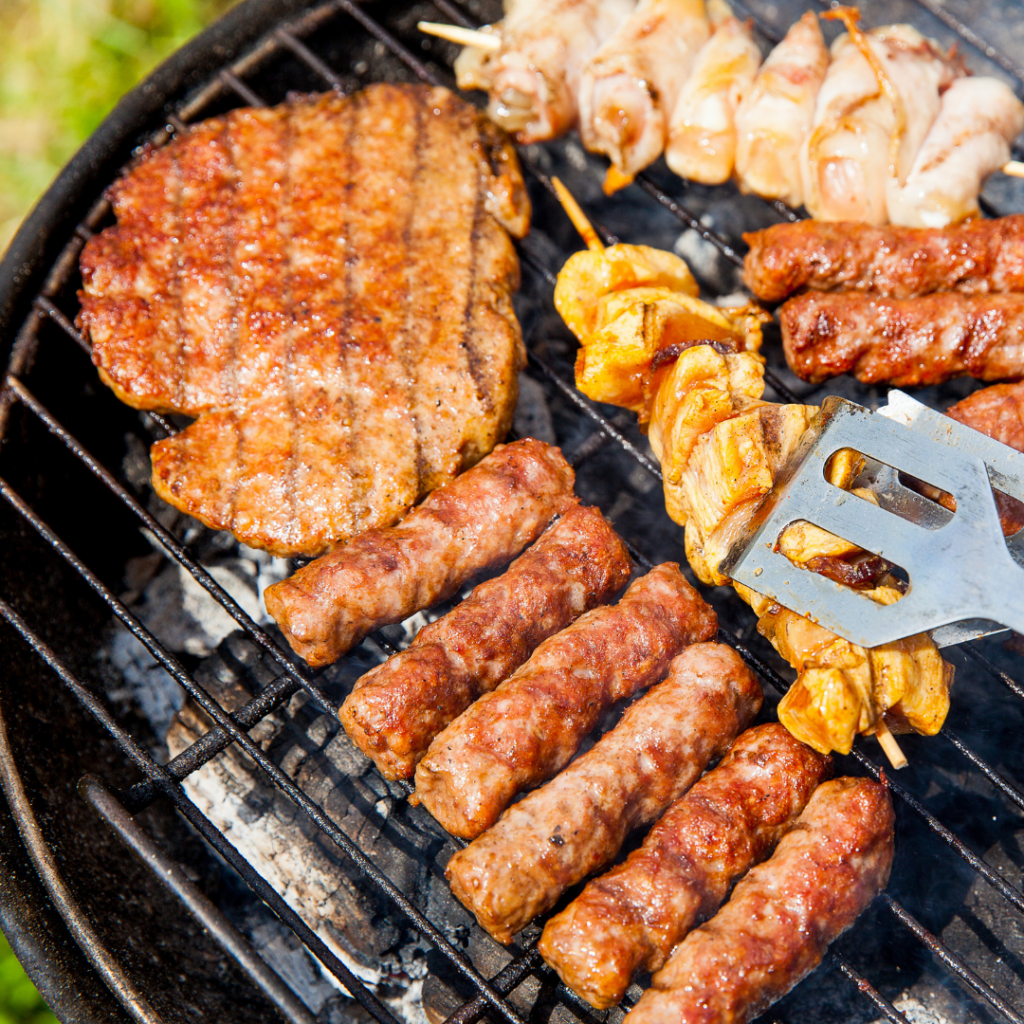 Various meat being cooked on the barbecue.