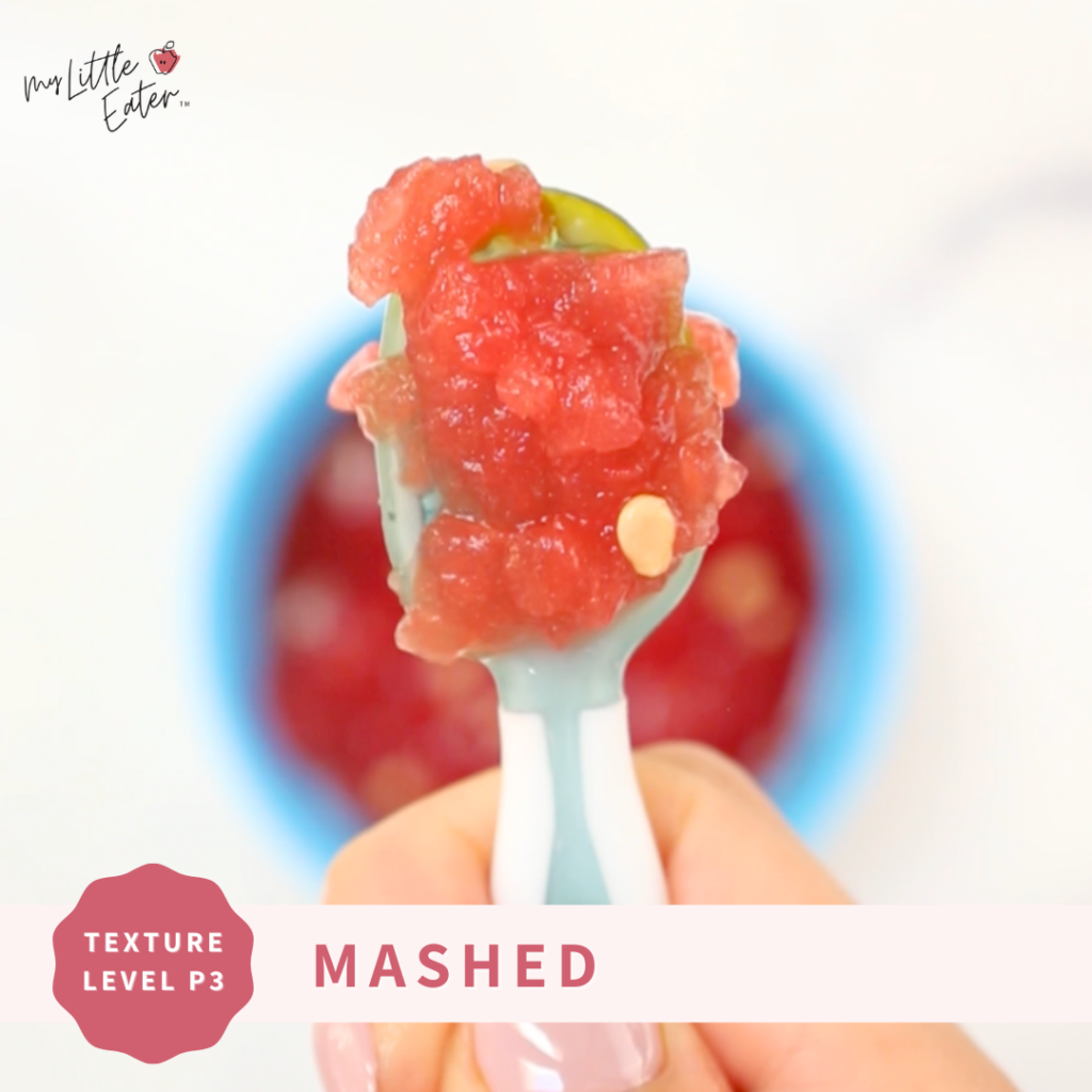 Mashed watermelon on a spoon as per phase 3 of My Little Eater’s Texture Timeline™; it even has white watermelon seeds in it and contains a lot of watermelon juice.