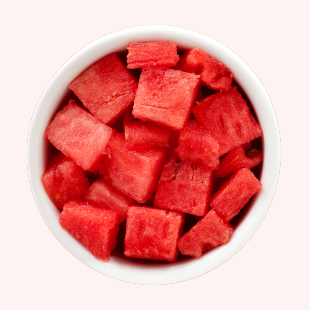 A white bowl filled with watermelon cubes.