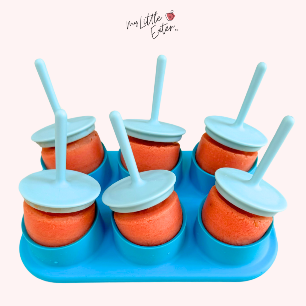 Six watermelon popsicles for baby led weaning in a blue popsicle mold.