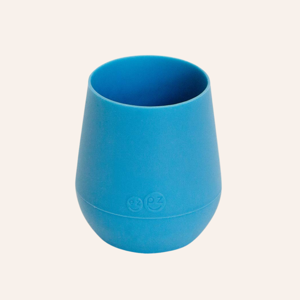 Young babies drink water easier using a small cup like this blue ezpz tiny cup.