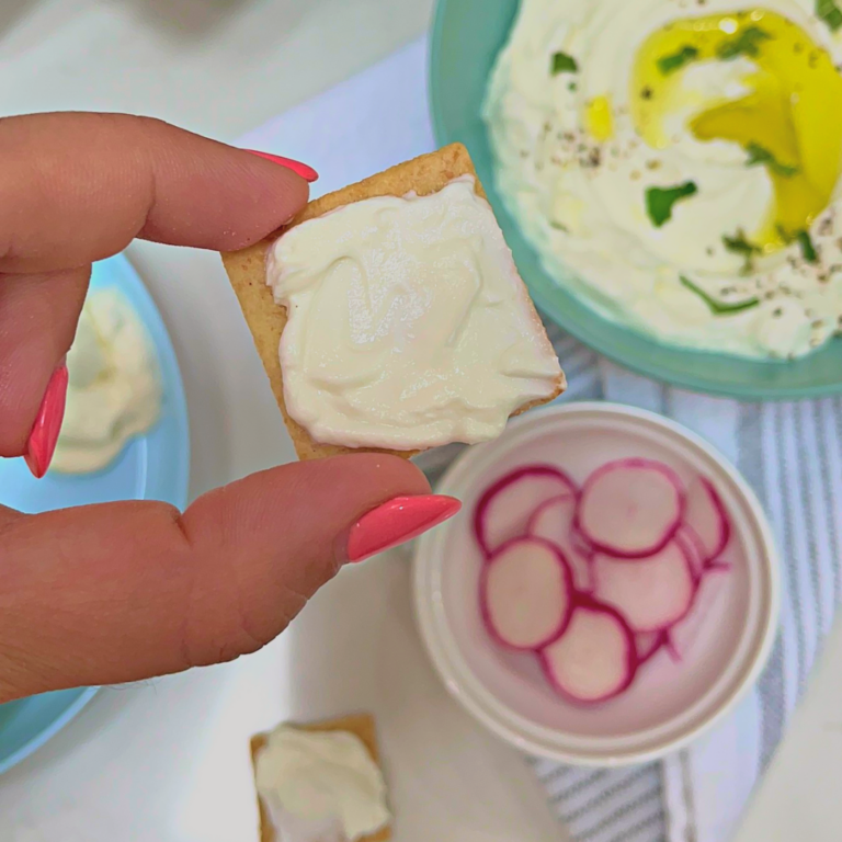 Labneh spread on a cracker for babies and toddlers.